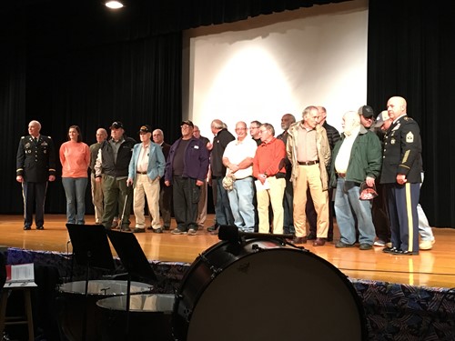 Veterans pose for a picture following the program at Central Arts Auditorium.
